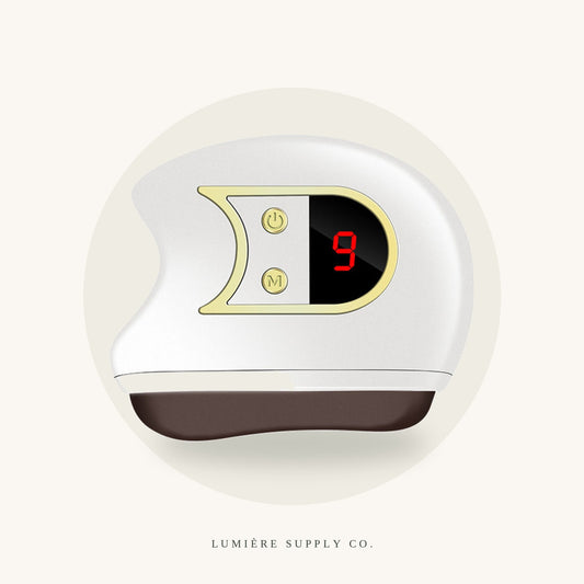 Lumière Sculpt heated gua sha device on a cream background
